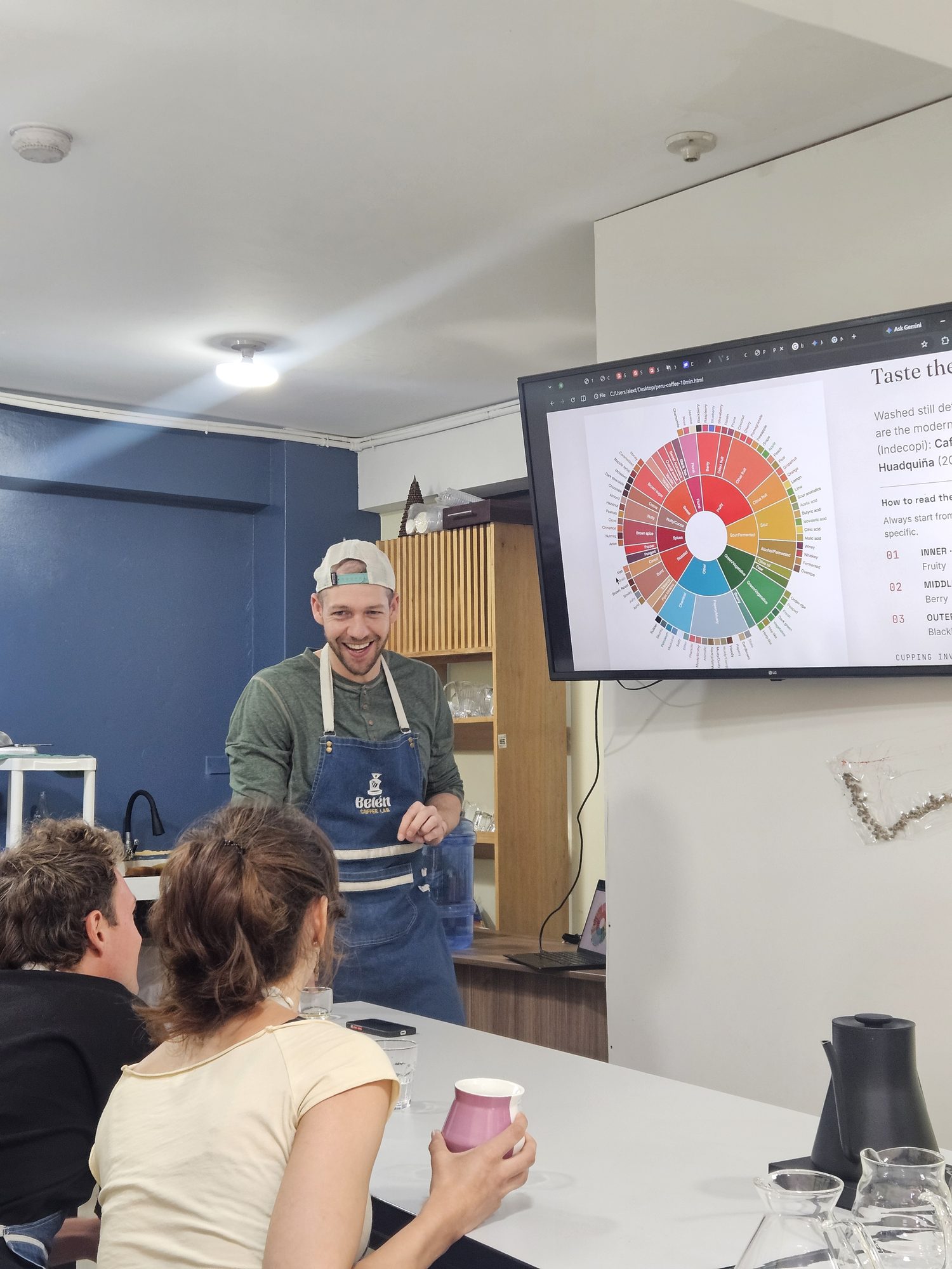Host introducing the workshop, with a V60 and espresso machine behind him at the Cusco coffee lab