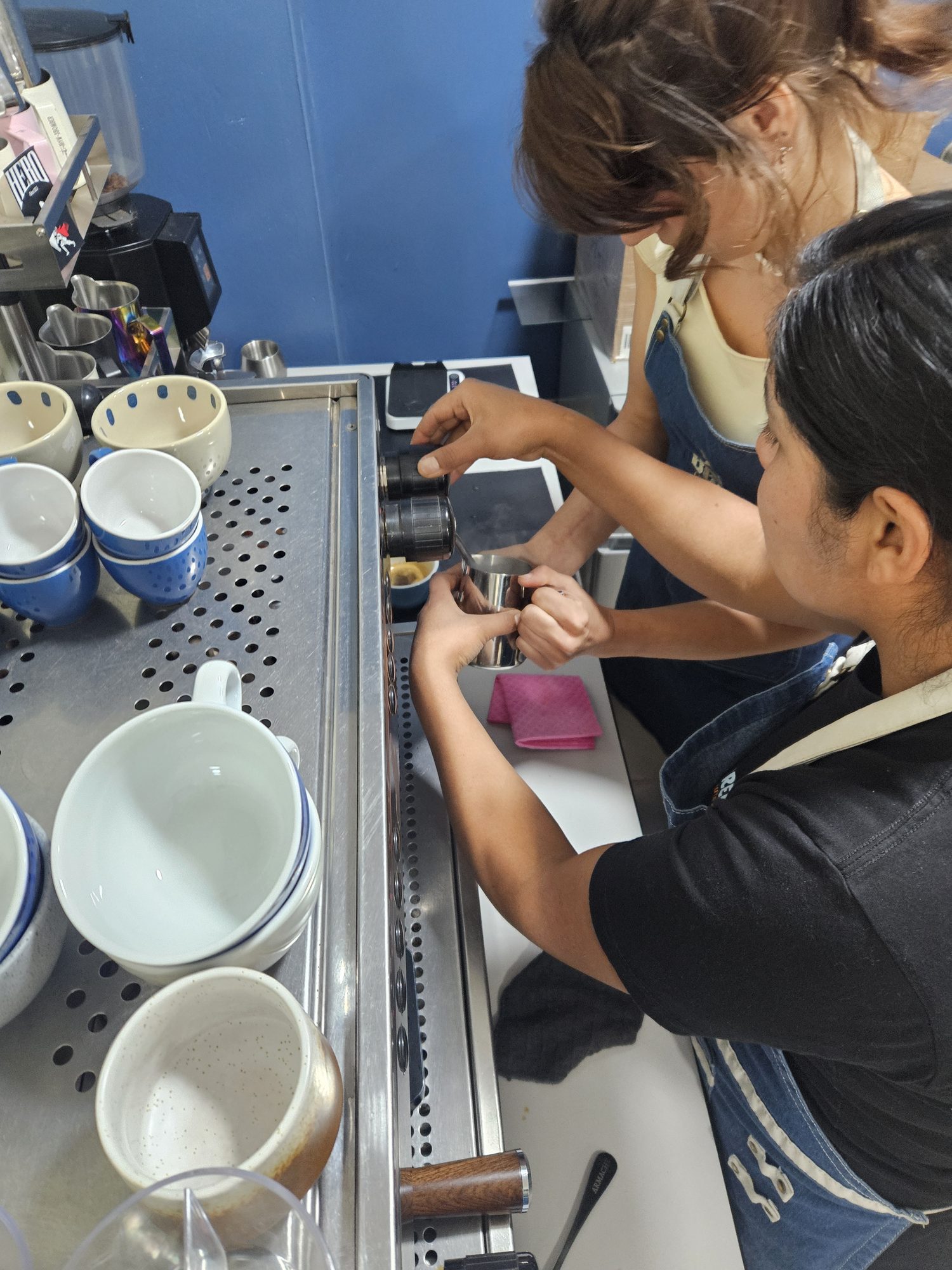 Espresso pouring into a glass on the scale at the Cusco coffee lab