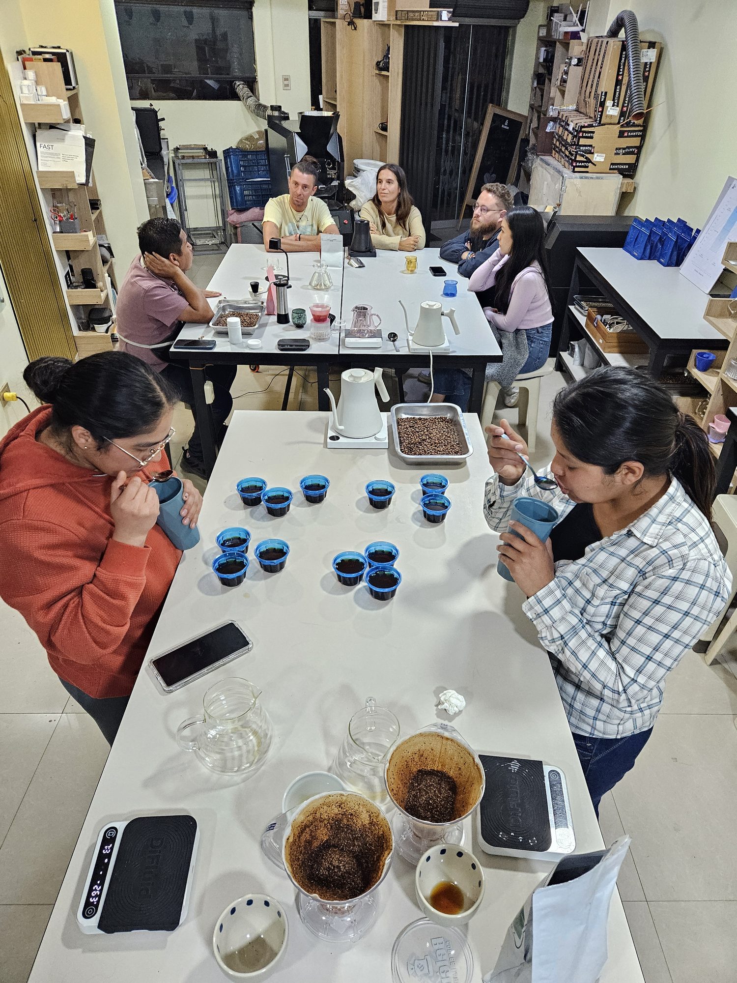 Wide view of the Cusco coffee lab, with the roaster, brew bar, and guests at class